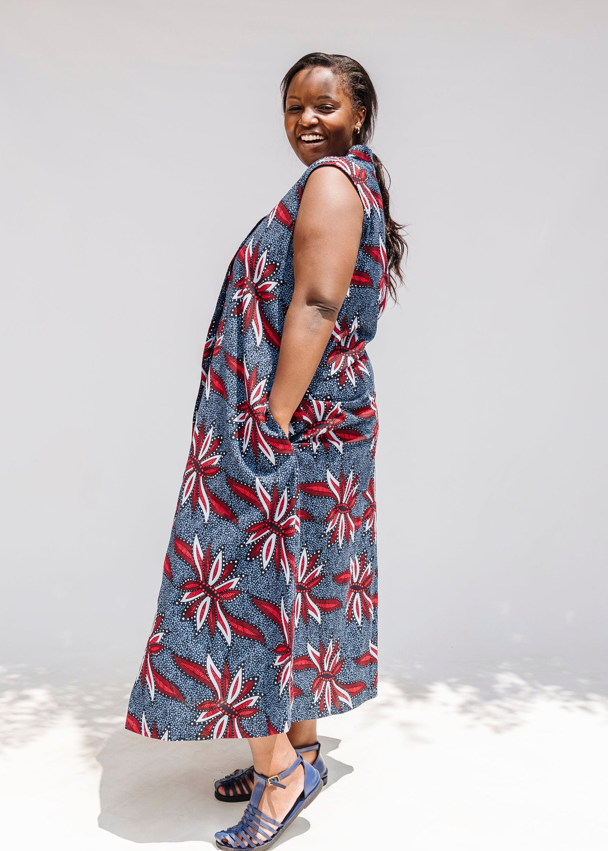 Model wearing grey, red and black dragonfly print dress.