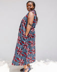 Model wearing grey, red and black dragonfly print dress.